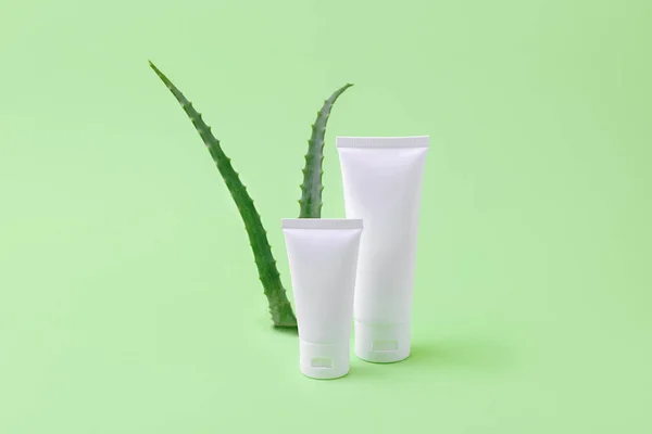 Blank cosmetics tubes with aloe vera on background.Organic cosmetic concept.