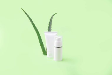 Boş kozmetik tüp ve arka planda aloe vera ile dağıtıcı. Organik kozmetik konsepti.