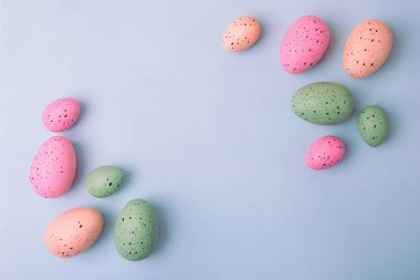 Frame from multicolored eggs on blue background,Easter concept.