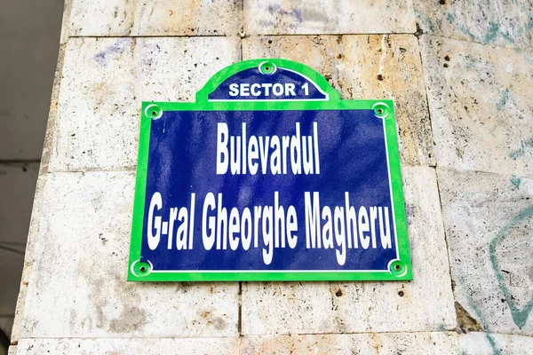 Beautiful vintage street sign showing Bulevardul General Gheorghe Magheru (Gheorghe Magheru Boulevard) displayed on an street in the old city center of Bucharest, Romania, in a sunny day