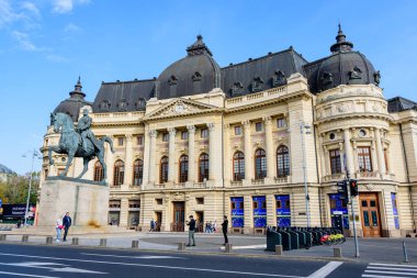 Bucharest, Romania - 6 November 2021: The Central University Library with equestrian monument to King Carol I in front of it in Revolutiei Square (Piata Revolutiei) in Victoriei Avenue (Calea Victoriei)
