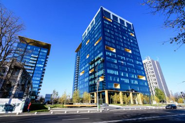 Bucharest, Romania, 21 Nov 2021: Modern glass building of Floreasca One Tower in Floreasca neighborhood in a sunny autumn day 