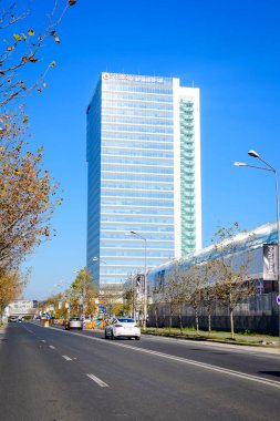 Bucharest, Romania, 21 Nov 2021: Modern glass building of Globalworth Tower in Aurel Vlaicu neighborhood in a sunny autumn day  clipart