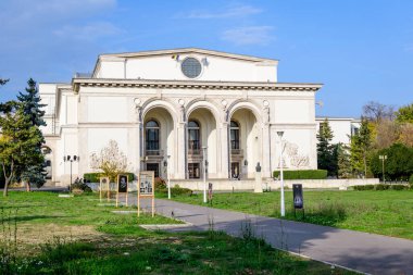 Bucharest, Romania, 6 November 2021 - Romanian National Opera building in a sunny autumn day with white clouds and clear blue sky