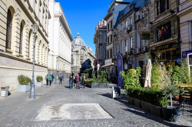 Bucharest, Romania, 20 November 2021: Old buildings with bars and restaurants on Lipscani Street (Strada Lipscani) in the historical center (Centrul Vechi) in a sunny autumn day