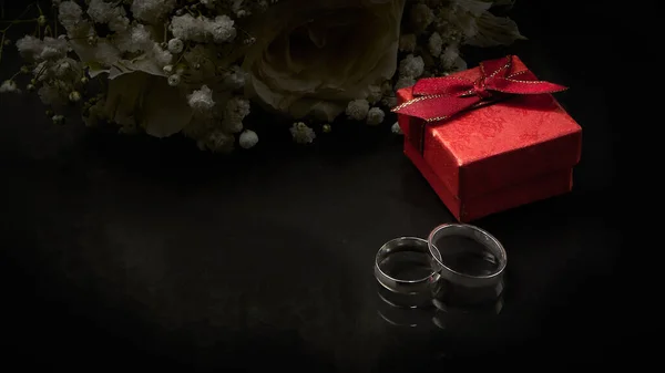 Two Silver Rings Red Gift Box Lie Dark Background Close — Stock Photo, Image