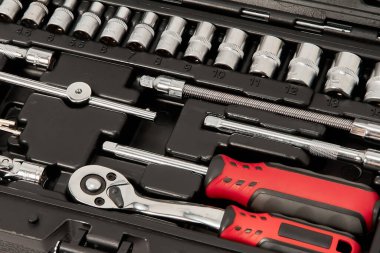 A repair kit in a plastic case, close-up, floating focus.