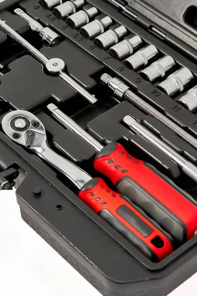 A repair kit in a plastic case, close-up, floating focus.