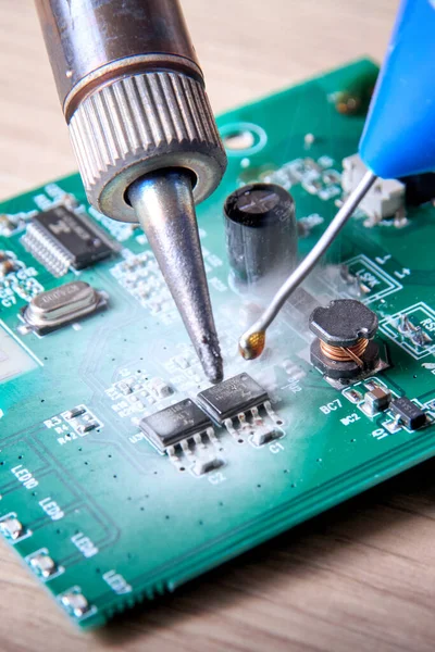 stock image Unprofessional repair of the electrical board of the device, poorly executed repair work, poor quality soldering, solder residue, damage to components during soldering, unprofessional repair.