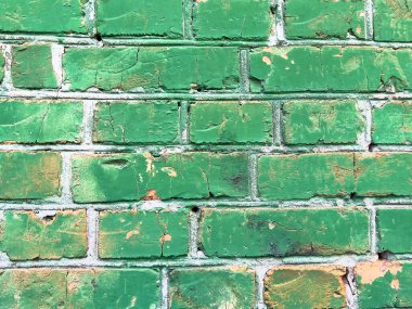 Kırık yeşil boya desenli eski tuğla duvar.. 