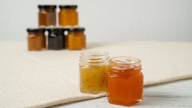 Set of glass jars with a variety of jams. Small jam jars with homemade jam. Different marmalade in small jars