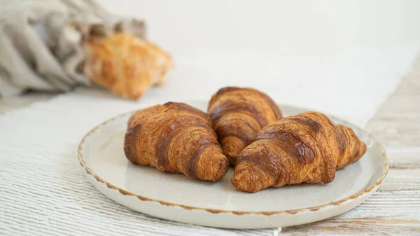 stock image Delicious croissants and an artisanal ciabatta in an eco-friendly linen bread bag, arranged on a table with a lovely tablecloth.