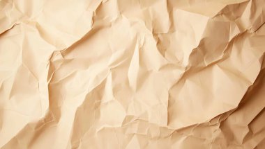 A close-up view of crumpled beige paper, showcasing unique textures and folds for creative backgrounds or design projects. clipart