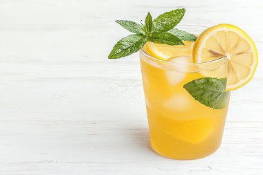 Refreshing lemon drink with mint leaves and ice in a clear glass, perfect for summer hydration and enjoyment. clipart