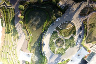 Garden, park in aerial view or top view. Green zone in city with beautiful landscape consist of plant, tree, water in lake or pond, roundabout or road for travel, parking, U-turn and decoration place.
