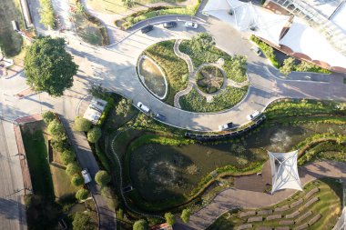 Garden, park in aerial view or top view. Green zone in city with beautiful landscape consist of plant, tree, water in lake or pond, roundabout or road for travel, parking, U-turn and decoration place.