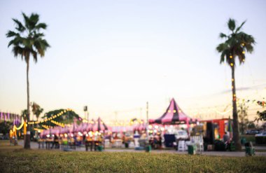 Blur image of flea market and food fair in Chiang mai city of Thailand. Also called festive food, street food. Marketplace consist of booth tent, shop, vendor and food stall. Busy with people. clipart