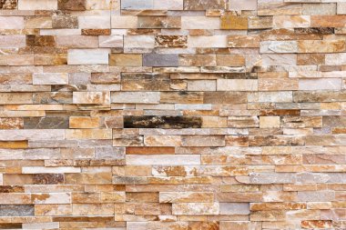 Doğal taş dokusu arka planı. Bej kahverengi renk. Kare dikdörtgen şekli yatay sıra çizgisi şeklinde. Mimari dekorasyon için malzeme, duvar kaplama paneli ön cephe, otel, havuz villası, tatil köyü.