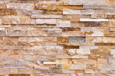 Doğal taş dokusu arka planı. Bej kahverengi renk. Kare dikdörtgen şekli yatay sıra çizgisi şeklinde. Mimari dekorasyon için malzeme, duvar kaplama paneli ön cephe, otel, havuz villası, tatil köyü.