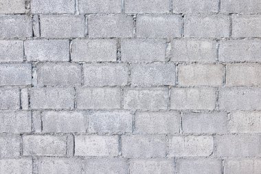 Beton blok arka plan genişliği ve yatay bileşimi kaba yüzey dokusu çimento ve çakıldan oluşur. İnşaat çalışmalarında sıralı dizilmiş dikdörtgen şekilli taş kalıpları.