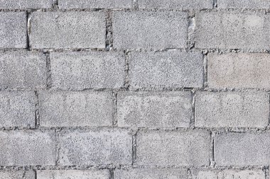 Beton blok duvar arka planı, sert beton ve çakıl yüzeyinden oluşur. İnşaat işlerinde dikdörtgen şekilli duvarların üst üste dizilmiş yatay şekli. Arkaplan için uygun.