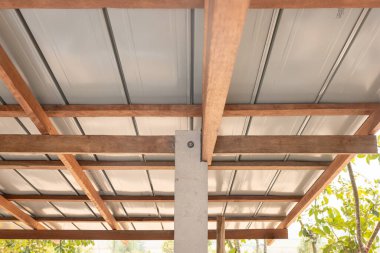 Çatı katındaki ahşap bağlantı noktası çivili kiriş, kiriş ve fındık cıvatasıyla onarılmaktan oluşuyor. Metal kaplama üstte. Ahşap iskeletli ev inşaatı.