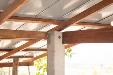 Çatı katındaki ahşap bağlantı noktası çivili kiriş, kiriş ve fındık cıvatasıyla onarılmaktan oluşuyor. Metal kaplama üstte. Ahşap iskeletli ev inşaatı.