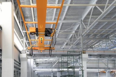 Fabrikanın içindeki vinç ya da depo binası. Endüstriyel makine ya da kaldırma ekipmanları, üretim tesisi için kiriş kirişleri yapısı üzerinde çekiş, kanca ve tel halattan oluşur..