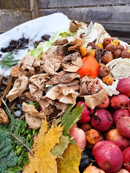 Wooden compost bin in winter, food waste, zero waste, organic recycling, ecological composting of food and garden waste. compostable things, rotten food