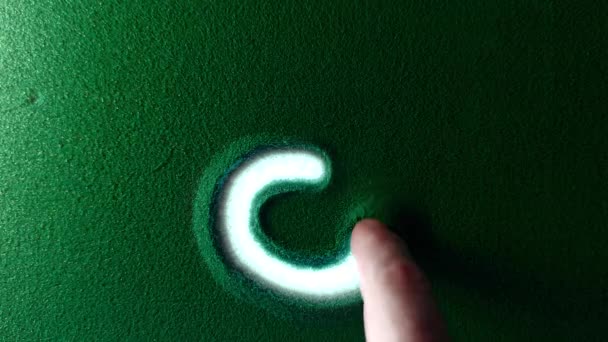手绘金牛座星座标志符号在绿沙中 雄鸟的手在绿色沙滩上用白色背光写下白羊座星座符号 顶视图4K分辨率 — 图库视频影像