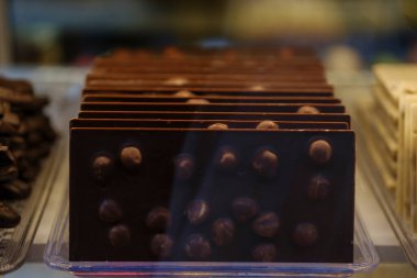 Chocolate bar with hazelnuts on Showcase. Selective Focus.