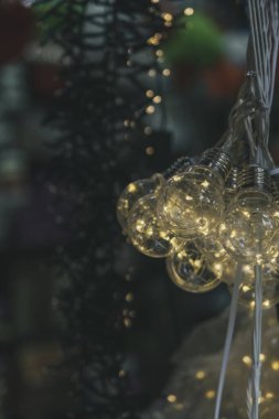 Colorful close up details of christmas fair market. Lighting Equipment decorations for sales. Selective Focus Ornament. Blur 