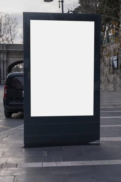 Blank billboard on roadside, pavement and under cloudy sky. Ideal photo for Istanbul city life. selective focus billboard.