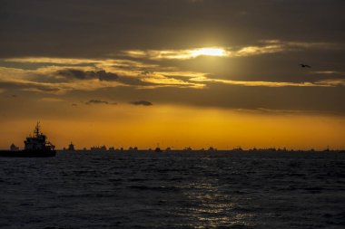 Ships waiting in the Marmara Sea to pass through the stanbul Bosphorus. cloudy sunset. backlight.