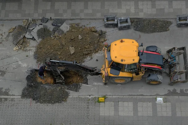 掘削機は夏の日に下水道嵐ハッチ通りを修復します 選択的フォーカスマシン トップ表示 — ストック写真