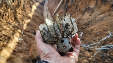 parts mortar mine in hand of a soldier. shank in hand, mortar mine tail. exploding shell. in the trench after the battle. ammunition shank. war. conflict. Russian-Ukrainian war in Donbass clipart