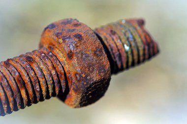 Paslı fındık. Vidalı paslı demir çubuk. Paslanmış mekanik bileşenler. Sürgülü ve fındıklı yakın çekim. Parçalanan konsept, sökülmesi zor, çıkarılamaz. seçici odak