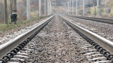 the railway goes into the distance, the rails are sleepers. branch of the high-speed railway. mirror surface of the rails. concept of travel, business trip, tourism, long journey clipart