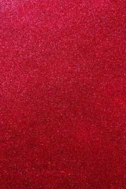 Işıltılı bir arka plan. Arkaplanda simler var. Parlak desenli yüzey. Dikey görüntü. Koyu kırmızı. Yumuşak ışık