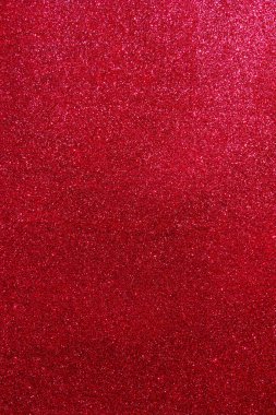 Işıltılı bir arka plan. Arkaplanda simler var. Parlak desenli yüzey. Dikey görüntü. Koyu kırmızı. Yumuşak ışık