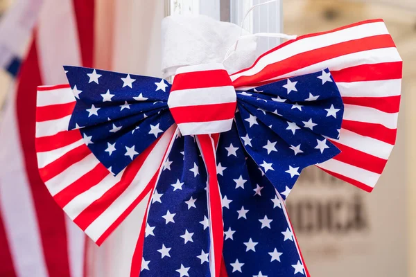 Symbolic bow tie in the form of the American flag. Days of American Culture. Patriotism and national pride. Background with selective focus and copy space