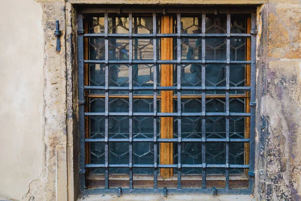 Ground floor window with wrought iron bars. Background or backdrop. Detail or element of classic old retro vintage exterior.
