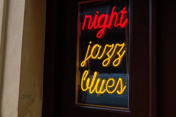Glowing neon inscription night jazz blues. Background with selective focus and copy space for text