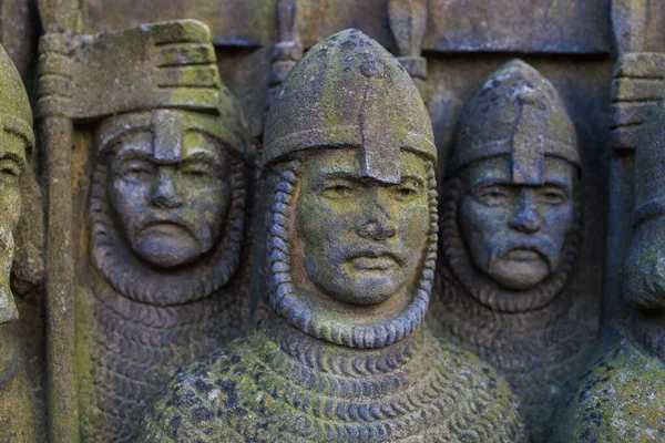 Warriors troops. Ancient bas-reliefs in the architecture of the city. Historical and cultural heritage. Background with selective focus and copy space