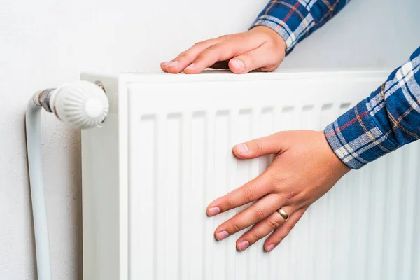 stock image Hands on the radiator of the heating system, selective focus. Background with copy space