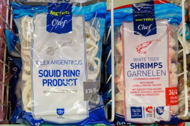 Frozen squid rings and shrimp on the store shelf. Illustrative editorial. May 12, 2022 Balti Moldova