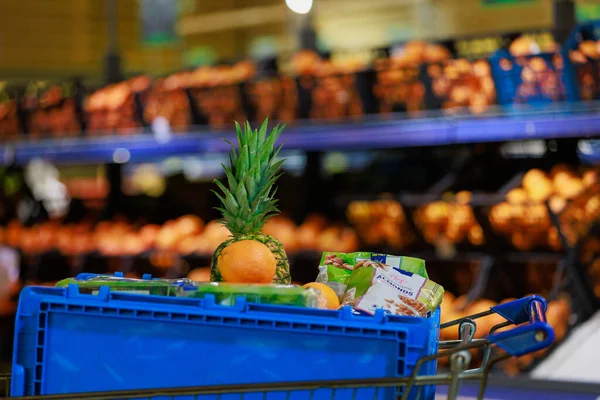 A box with products in a grocery cart for collecting an online order and delivering it to a customer. Illustrative editorial. April 19, 2022 Balti Moldova