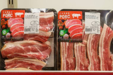 Slicing raw pork meat on a store shelf. April 30, 2022 Beltsy Moldova.