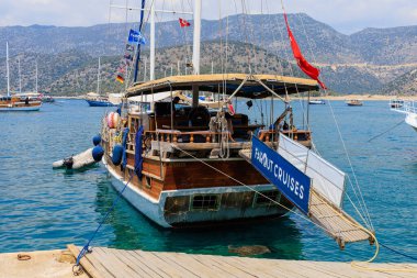 A small port in the Turkish bay with pleasure yachts on the rocky coast of the Mediterranean Sea. August 10, 2022 Demre, Antalya province, Turkey.
