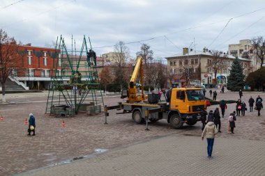 Background of assembling artificial urban Christmas tree in the Christmas town. December 17, 2021 Balti Moldova